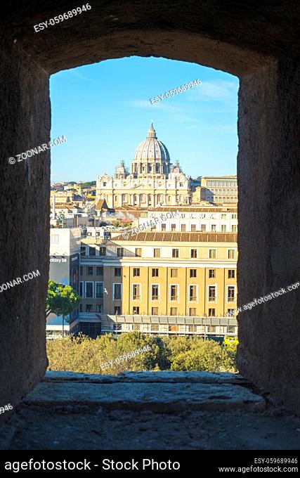 Vatican City, Vatican - February 4, 2018: View of Saint Peter's Basilica framed by a window in Castel Sant'angelo. Vertical