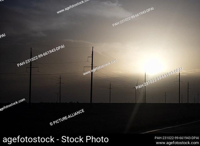 21 October 2023, Ukraine, -: Electricity pylons stand in the dawn. Photo: Sebastian Gollnow/dpa. - -/Odessa/Ukraine