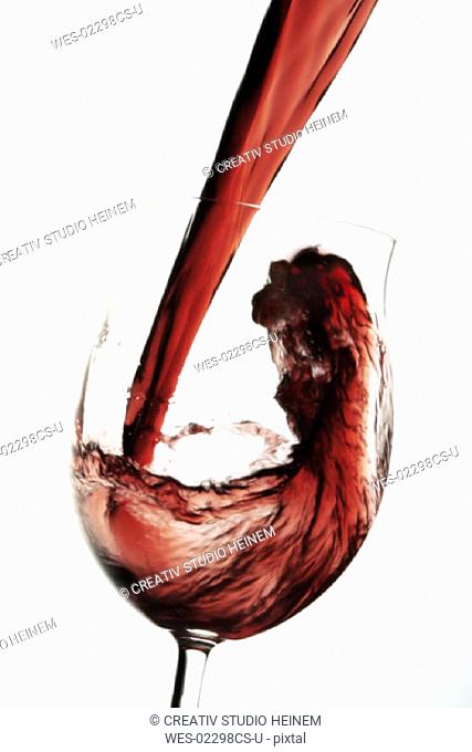 Red wine pouring into glas
