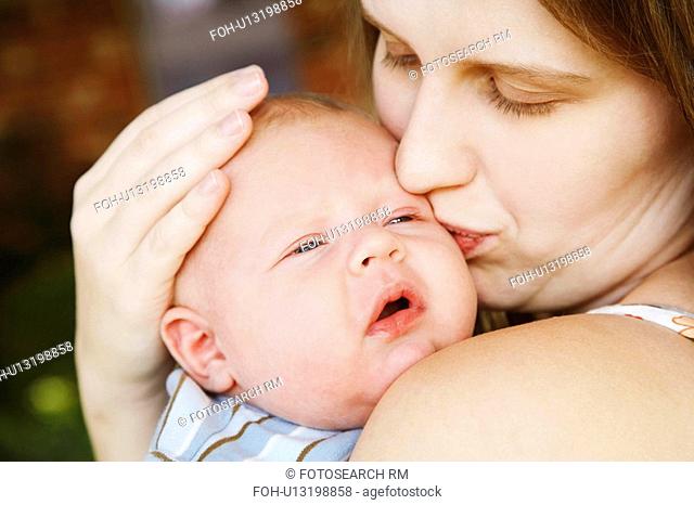 woman baby closeup young kissing son 1215 months