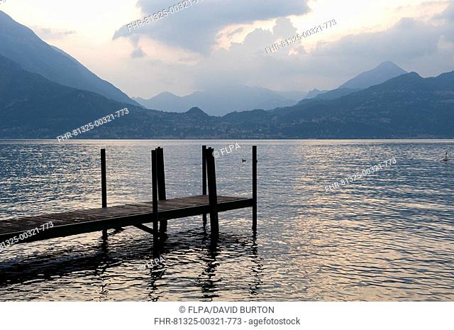 Wooden jetty and lake at sunset, Varenna, Lake Como, Lombardy, Italy