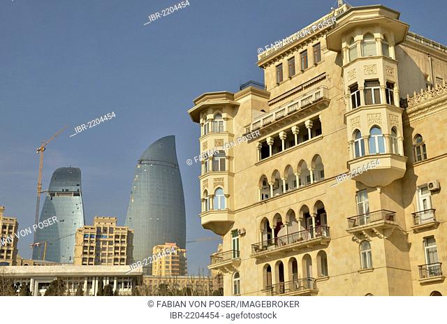 Art Nouveau building on the Bulevar beach promenade in front of the facade of two of the three high-rise buildings Flame Towers, the new landmark of the city