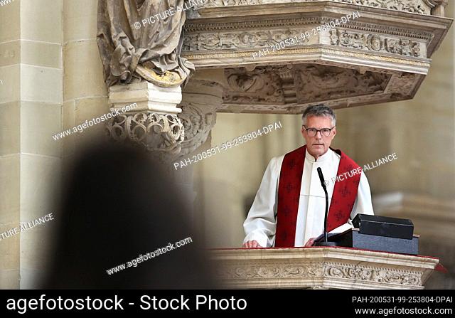 31 May 2020, Saxony-Anhalt, Magdeburg: Cathedral preacher Jörg Uhle-Wettler speaks to believers from the alabaster pulpit during the service on Pentecost Sunday...