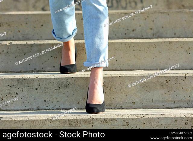 Front view close up of a woman legs wearing high heels walking down stairs