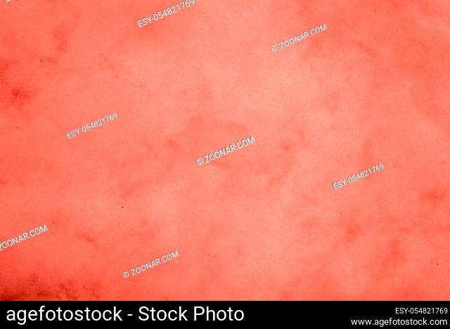 Coral pink color toned paper parchment background texture with stains