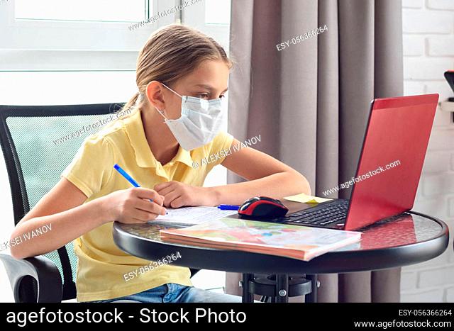 Girl at home studying online during quarantine