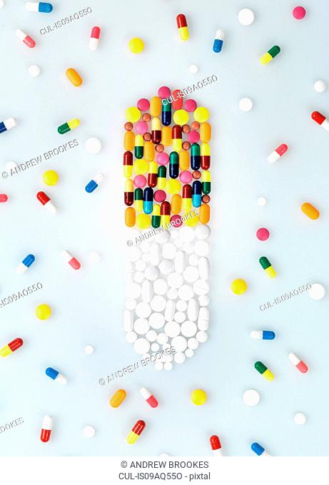 Medical pills and tablets in shape of drug capsule and scattered