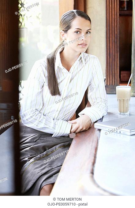 Businesswoman at a bar with laptop