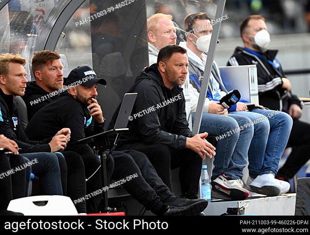 02 October 2021, Berlin: Football: Bundesliga, Hertha BSC - SC Freiburg, Matchday 7 at the Olympiastadion. Hertha's head coach Pal Dardai (M) sits next to his...