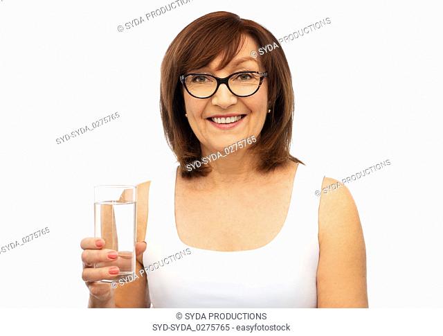 senior woman in glasses with glass of water