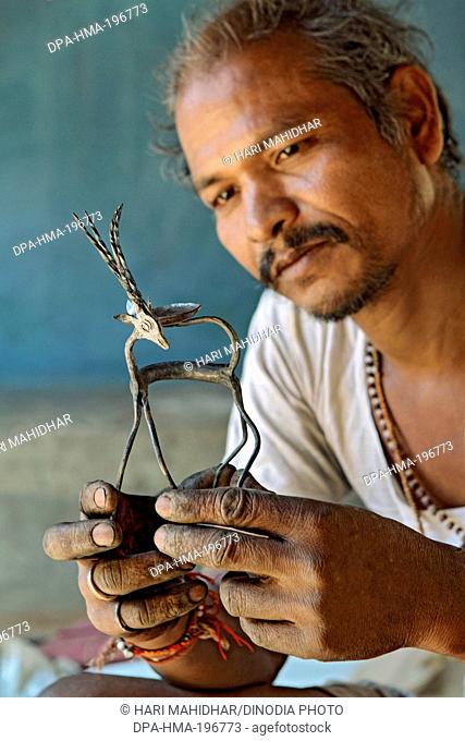 Ironsmith holding statue, narayanpur, bastar, chhattisgarh, india, asia