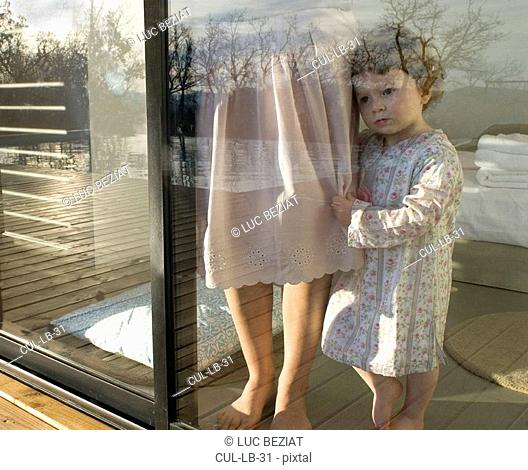 Mother and daughter 9-12 months looking through window