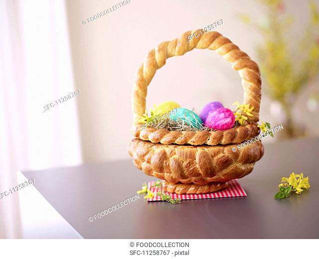 A Easter basket made of bread filled with Easter eggs