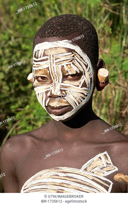 Surma Woman with facial and body painting and earlobe plates, Kibish, Omo River Valley, Ethiopia, Africa