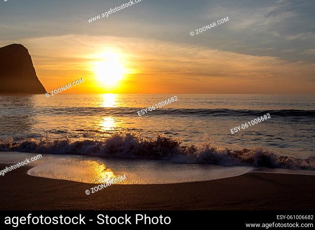 Sunset at Unstad Beach, the surfers paradise in Lofoten Islands, Norway. Mountain, ocean, waves and sunset