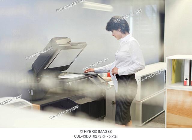 Businesswoman making copies in office