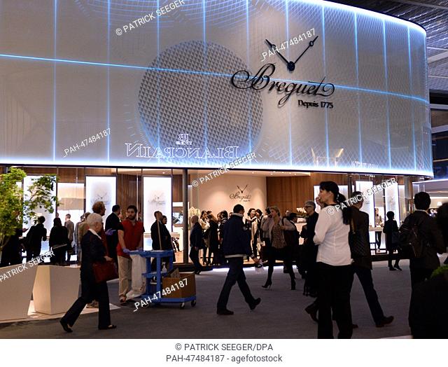 Fair visitors walk past the stand of watch manufacturer Breguet at the International watch and jewellery fair Baselworld 2014 in Basel,  Switzerland