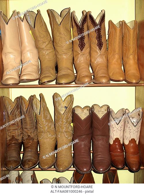 Rack of cowboy boots in thrift store