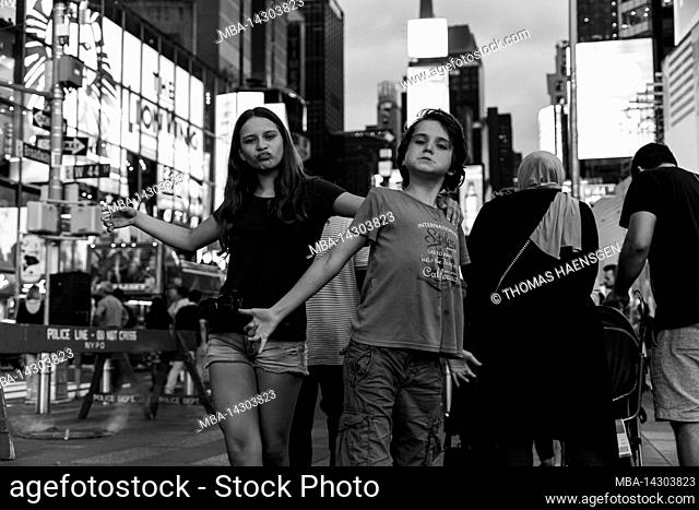 Theater District, New York City, NY, USA, 14 years old caucasian teenager girl and 12 years old caucasian teenager boy - both with brown hair and summer styling...