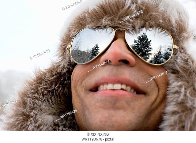 A man wearing a deerstalker hat and sunglasses