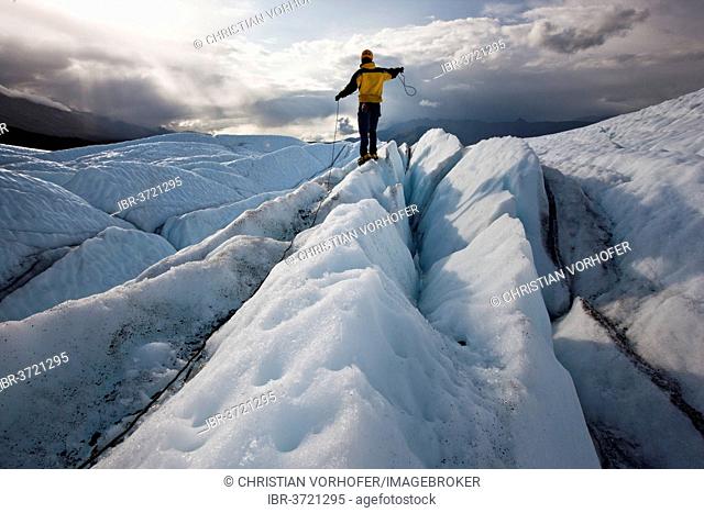 Mountaineer standing on Matanuska Glacier and pulling on a rope, Matanuska Glacier, Alaska, United States