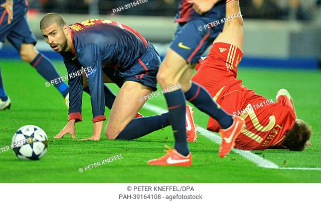 Barcelona's Gerard Pique (L) and Munich's Philipp Lahm vie for the ball during the UEFA Champions League semi final second leg soccer match between FC Barcelona...