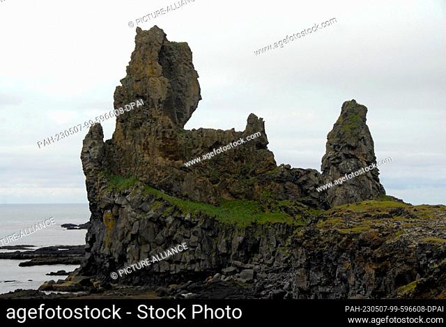 24 July 2022, Iceland, Lóndrangar: Rock formation are located in Lóndrangar on the Snæfellsnes Peninsula in Iceland. Rock needles are of volcanic origin