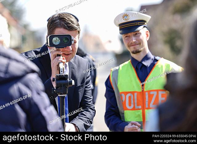 24 March 2022, Bavaria, Wendelstein: State Secretary of the Interior Sandro Kirchner (CSU, l) has a laser measuring device explained to him by a police officer...