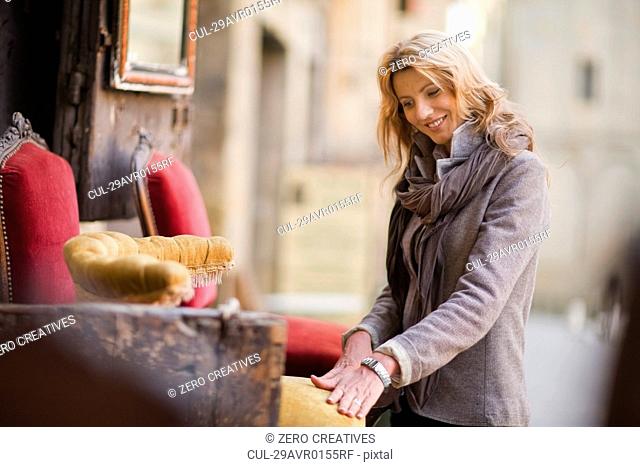 Woman marveling at antique furniture