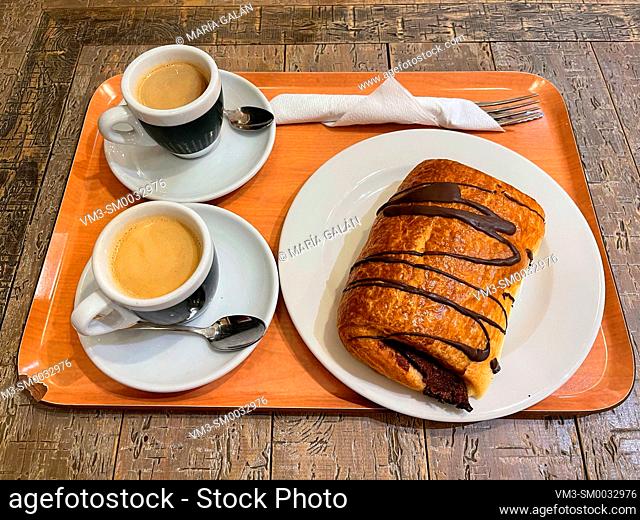 Two cups of coffee with puff pastry cake