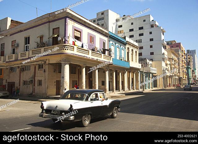 Old American cars used as taxi in front of the colonial buildings in Vedado district, Havana, La Habana, Cuba, West Indies, Central America