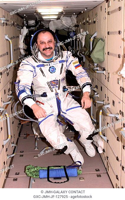 Cosmonaut Yury V. Usachev, Expedition Two mission commander, dons a Russian Sokol suit in the Zarya Functional Cargo Block (FGB) of the International Space...