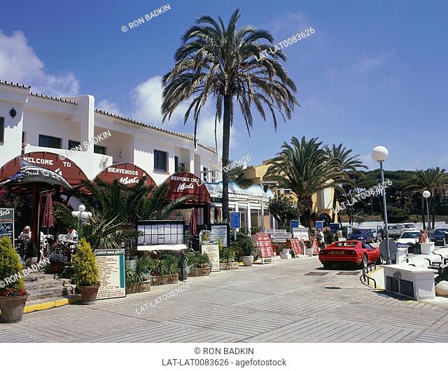 Puerto Cabopino. Quayside restaurants and bars. Red Ferrari sportscar