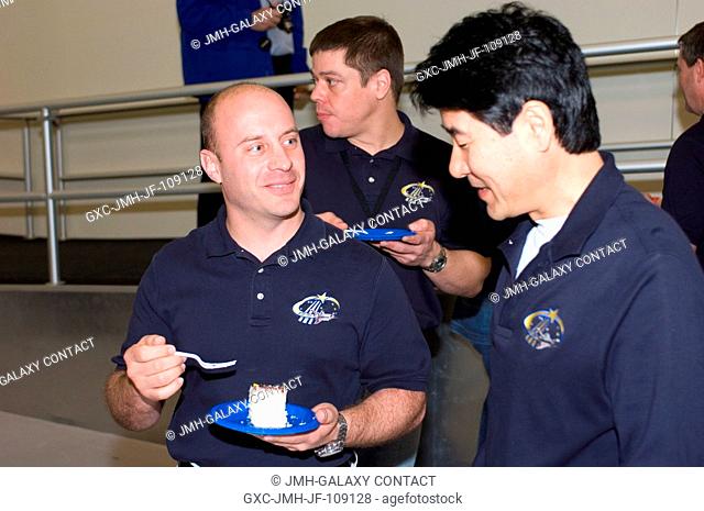 Japan Aerospace Exploration Agency (JAXA) astronaut Takao Doi (right)., NASA astronauts Garrett E. Reisman (left) and Robert L