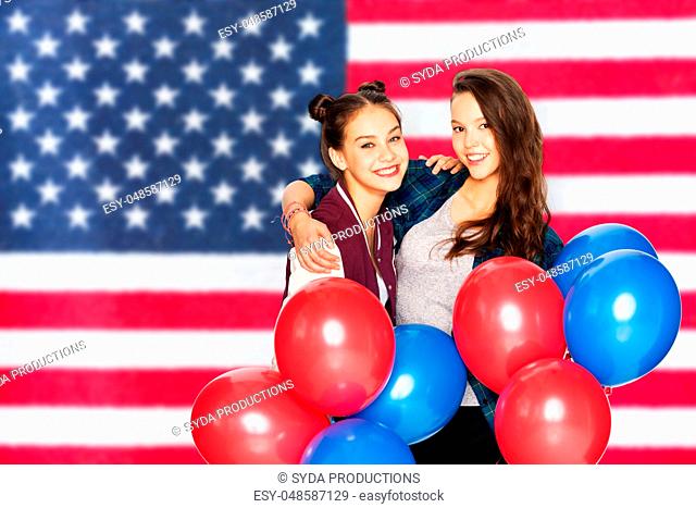 teenage girls with balloons over american flag