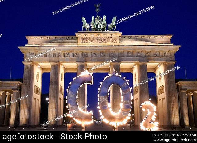 06 May 2021, Berlin: In a Greenpeace action, a CO-2 sign stands in front of the Brandenburg Gate with flames coming out of it