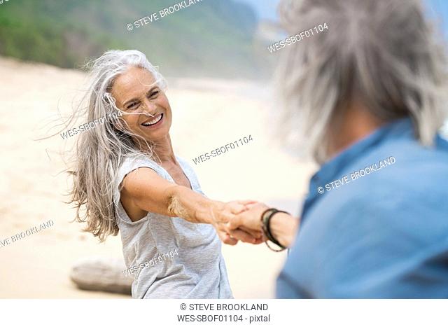 Handsome senior couple dancing on the beach