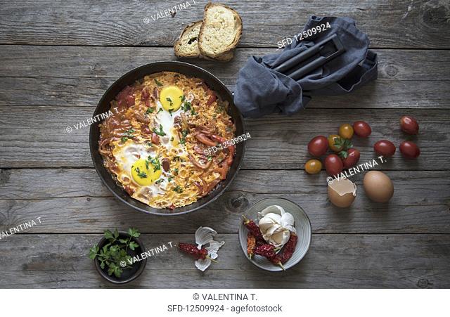 Shakshuka with tomatoes, peppers, onions and eggs