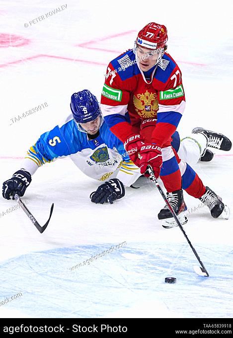 RUSSIA, ST PETERSBURG - DECEMBER 17, 2023: Kazakhstan's Nikita Grebyonkin (L) and Russia 25's Kirill Polokhov in action in their 2023 Channel One Cup ice hockey...
