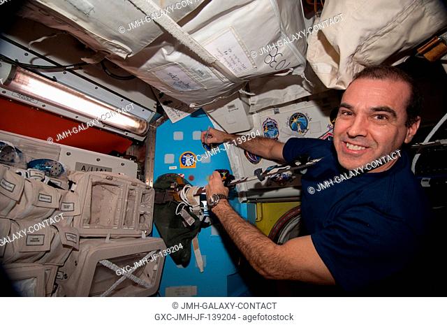 NASA astronaut Rick Mastracchio, Expedition 39 flight engineer, places his crew patch on the wall in the Quest airlock of the Earth-orbiting International Space...