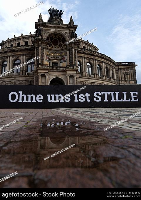 05 June 2020, Saxony, Dresden: A banner with the inscription ""Ohne uns ist Stille"" (""Without us there is silence"") has been hung up on a construction fence...