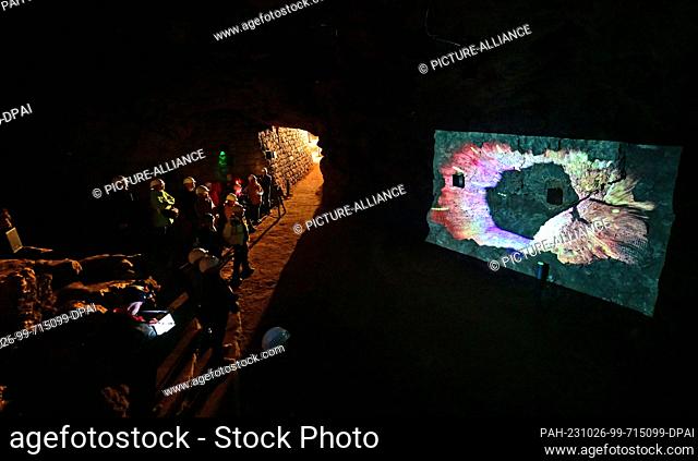 26 October 2023, Thuringia, Schweina: Visitors walk through the Altenstein Cave during the press tour before the reopening