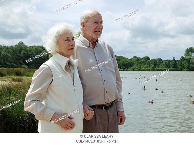 Elderly man holding elderly woman's hand