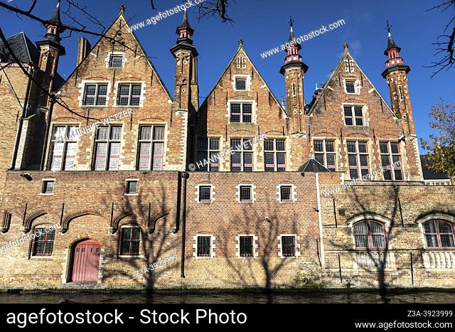 Old red brick buildings by a canal in the historical city centre of Bruges, Belgium, Europe