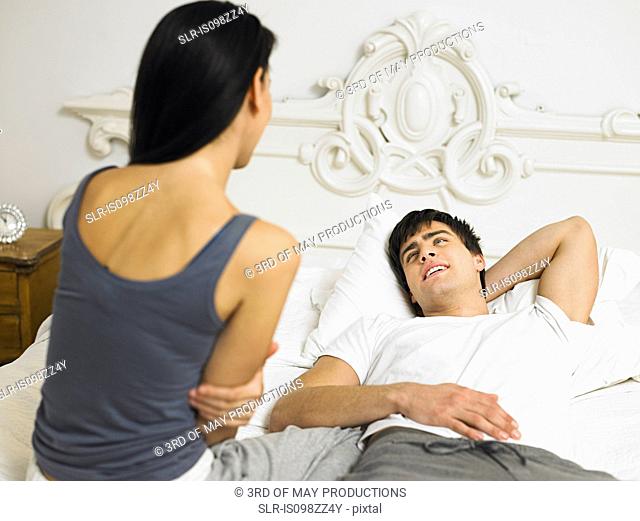 Young couple on bed together