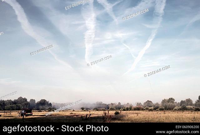 Landscape on the river Bank at dawn, beautiful clouds in the sky, fog over the river