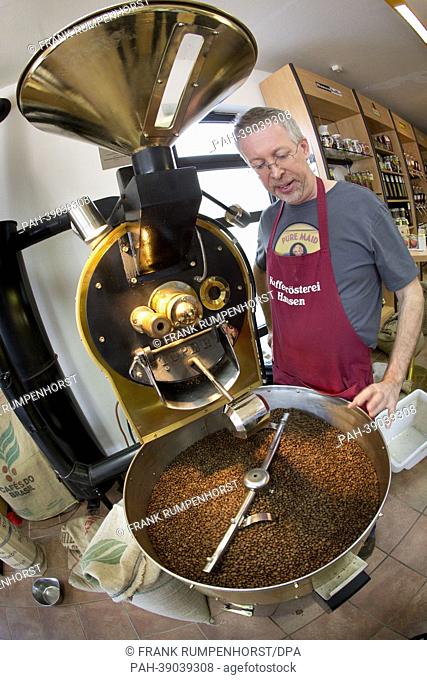 Thomas Hansen stands next to freshly roasted coffee beans that are cooling at the Hansen Coffee Rosters in Roedermark,  Germany, 25 April 2013