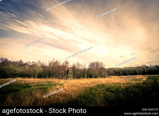 Hunting tower on a field in autumn scenery