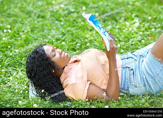 african student girl reading math textbook