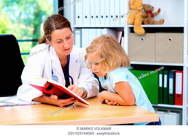 female pediatrician in white lab coat and the little patient